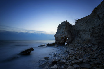 Seascape during sunset. Beautiful natural seascape, blue hour. Sea sunset at the Black sea coast near Balchik, Varna, Bulgaria. Magnificent sunset with clouds and rocks.