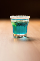 blue shot on bar with black background