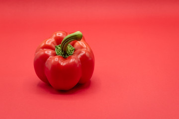 close up red bell pepper on red background with copy space