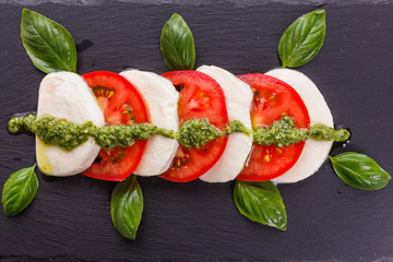 Caprese salad on a wooden rustic background