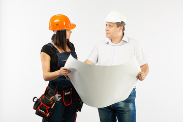 Portrait Of Male Architect And builder Woman Discussing building plan. foreman holding roll paper