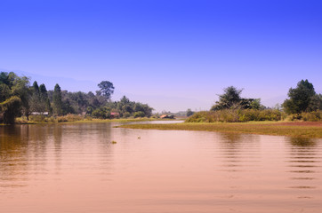 Blue sky with mountain landscape view reflects on water