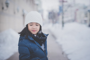  Asian girl enjoying snowfall