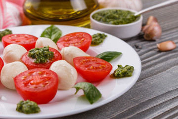 Caprese salad on a wooden rustic background