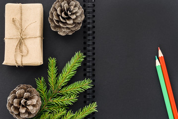 Christmas composition. Black Notebook with New Year decorations around