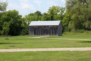 A old wooden barn on the farmland in the country.