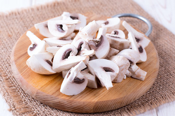 Chopped mushrooms on wooden chopping board