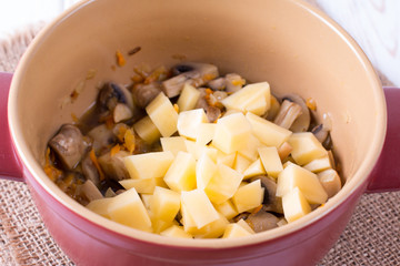 Add the potatoes to the vegetables in the pan