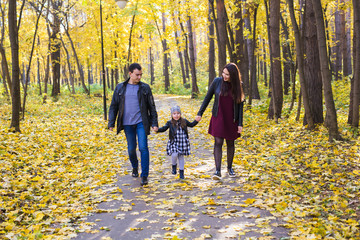 Parks, nature and family concept - Happy family walking in autumn park