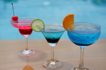 summer alcoholic drinks and cocktails at poolside bar