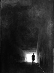 Silhouette of a man stood in a tunnel