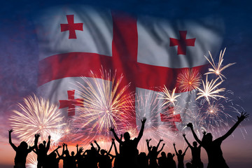 People are looking on fireworks and flag of Georgia