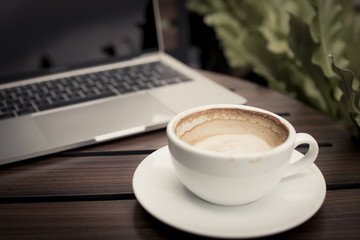 coffee on table with laptop working in cafe, relax and free time concept