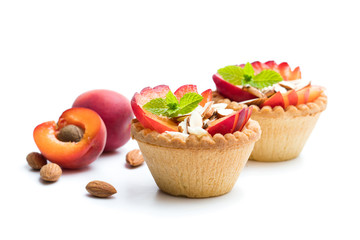Egg custard  tarts with fresh red apricot and almonds isolated on white