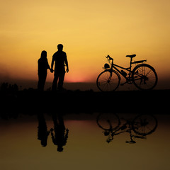 Fototapeta na wymiar silhouette of a couple riding bicycles