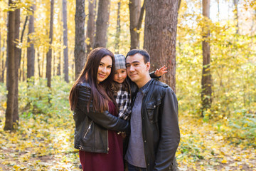 Fall, nature and family concept - Portrait of happy family over autumn park background