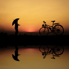 silhouette of a person riding a bike