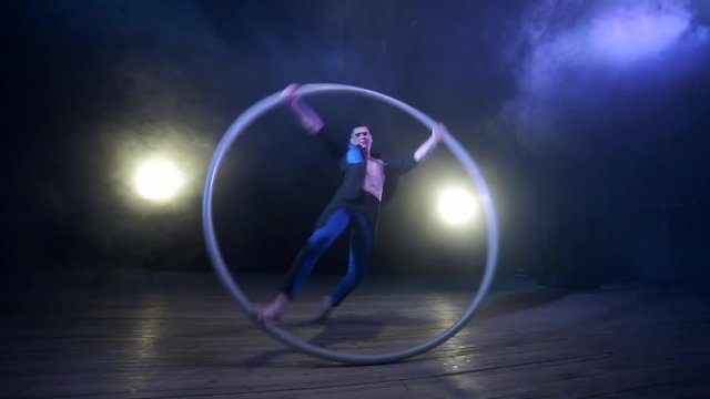 Circus artist spinning in a Cyr Wheel