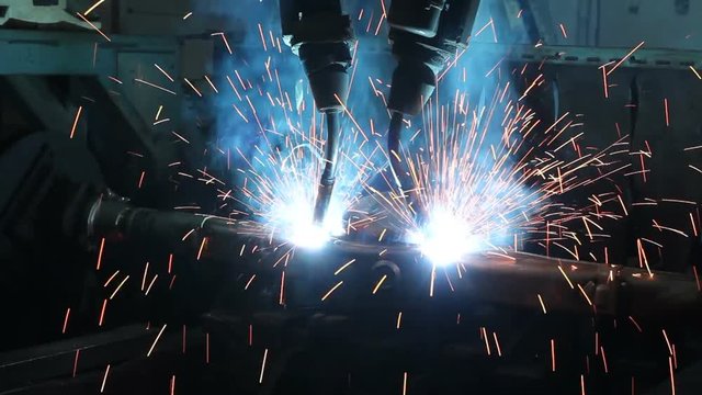 Welding robots movement in a car factory, automotive parts industry