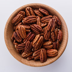 delicious pecan nuts on a white acrylic background