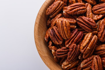 delicious pecan nuts on a white acrylic background
