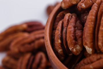 delicious pecan nuts on a white acrylic background