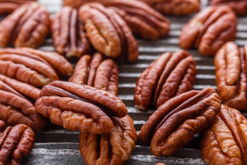 delicious pecan nuts on a rustic wooden background