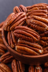 delicious pecan nuts on a dark stone background