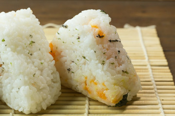 The Japanese food Onigiri  white rice formed into triangular or cylindrical shapes and often wrapped in nori.