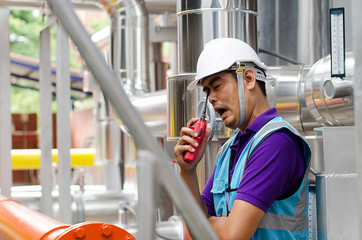 Oil Industry Pump jack with one oil worker who using a portable radio