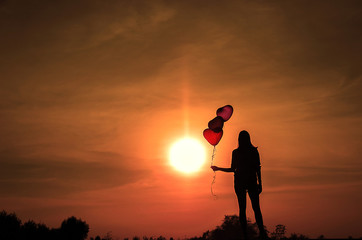 Silhouette, women with balloons in the heart
