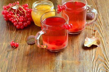 Red hot tea with viburnum berries in a glass cup, copy space
