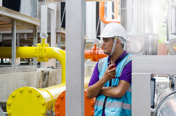 The male Asian engineers are examining the response and reporting coolant system via radio...