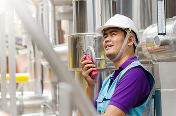 The male Asian engineers are examining the response and reporting coolant system via radio...