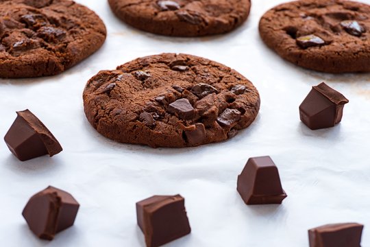 Close up image of chocolate cookies and piece chocolate bar