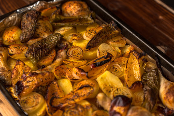 roasted chicken withpotatoes and vegetables on baking sheet