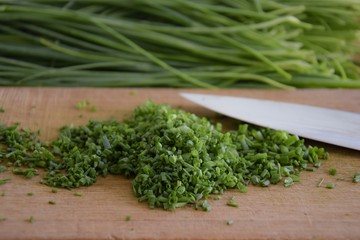 fresh bunch of chieves on a wooden cutting board