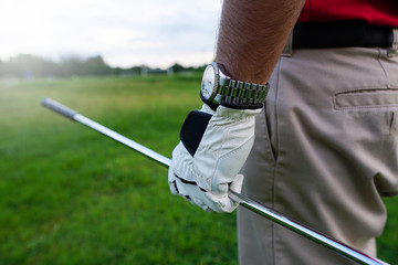 The golfer holding a golf club to hit a golf ball