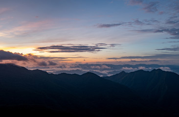 View of nature. The top of the mountain, the sun, the mist and the mountain. at Doi Phu Kha, Nan. Low light and noise.  ..