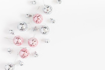 Christmas composition. Christmas balls, pink and silver decorations on white background. Flat lay, top view, copy space