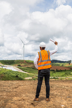 Male engineer checking and controlling with windmills for electric power plant

