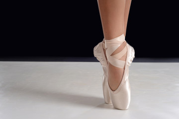 closeup of ballerina feet on pointe in pointe shoes - 222814319