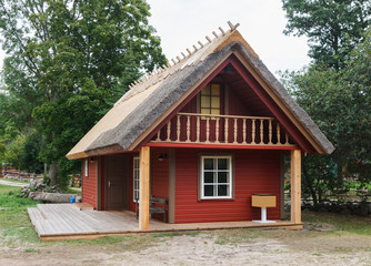 Fototapeta na wymiar Wooden cottage with straw roof.