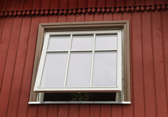 Red cottage with new plastic window.