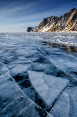 View of beautiful drawings on ice from cracks and bubbles of deep gas on surface of Baikal lake in winter, Russia
