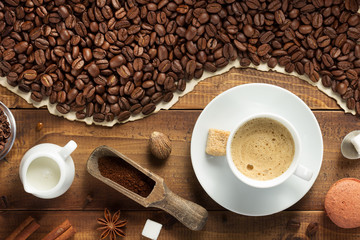 coffee beans and cup on wooden background