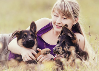 Naklejka na ściany i meble woman and German Shepherd puppy