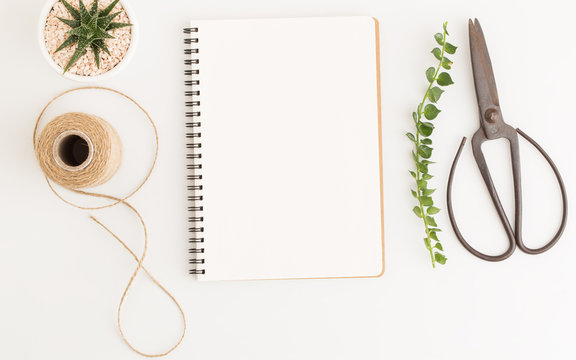 Blank notebook and scissors on white background, Top view image of white notebook and empty space for text