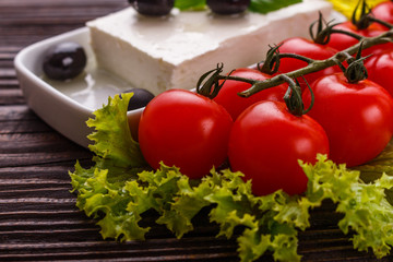A piece of feta cheese on a wooden rustic background