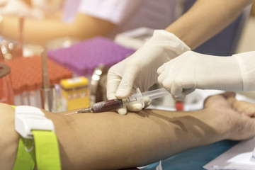 The doctor uses the patient's blood test tube.